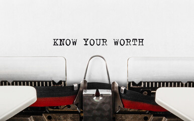Text KNOW YOUR WORTH typed on retro typewriter;
