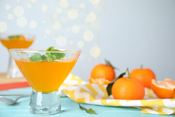 Delicious tangerine jelly on light blue wooden table