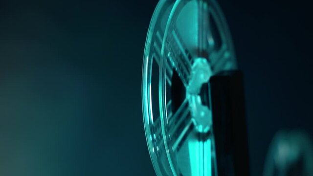 tilt shooting of super 8 camera film projector, blue light