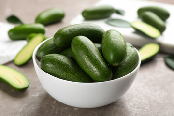Fresh seedless avocados on grey table, closeup