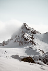 Fototapeta na wymiar Mountain Peak covered with Fog an Snow