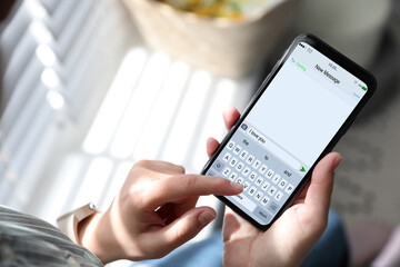 Woman sending message with text I Love You, closeup