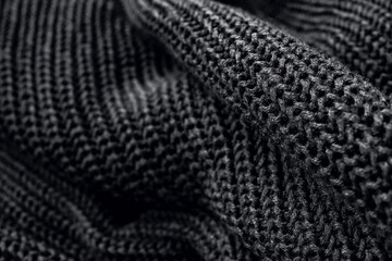 Closeup of the knitted fabric of a black sweater