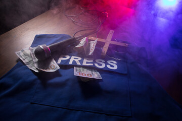 Media Journalism fake news concept. Blue journalist (press) vest in dark with backlight and fog....