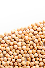 Pile of chickpeas arranged diagonally. image with copy-space and white background. Vegan food and nutrition.