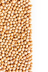 Pile of chickpeas arranged on the left with copy-space. White background. Health & Wellness. Food, nutrition and legumes.