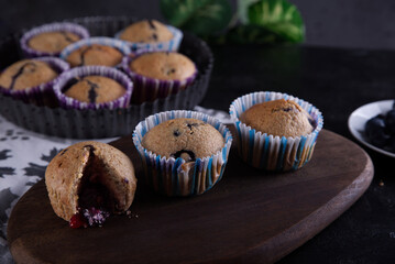 Delicious homemade cupcakes filled with blueberries and presented in small molds.