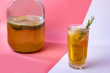 kombucha in a glass jar and glass with lemon and ice. Healthy drink