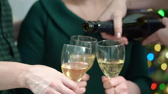 Women friends pour champagne into glasses at the festival. Bachelorette party. alcoholic beverages at a birthday or new year party.