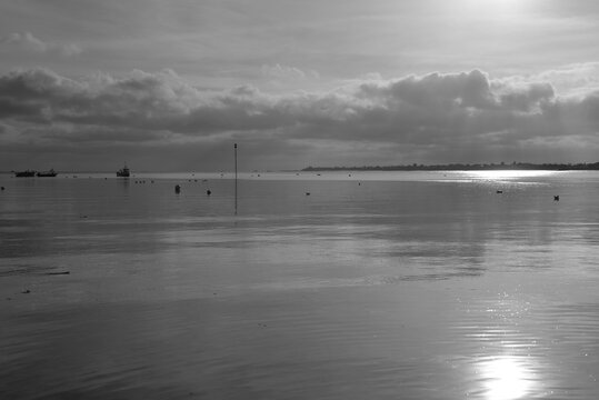 Grouville Bay, Jersey, U.K. B&W image of a calm rising tide in Winter.