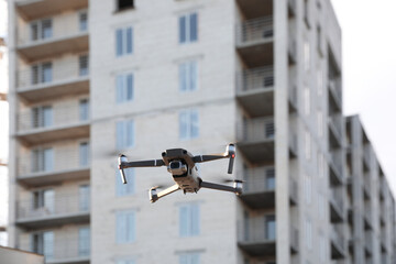 Modern drone flying at building site. Aerial survey