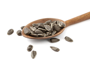Raw organic sunflower seeds in wooden spoon isolated on white
