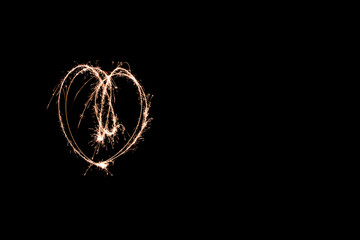 glowing heart light painting at night with a sparkler. creative movement photography