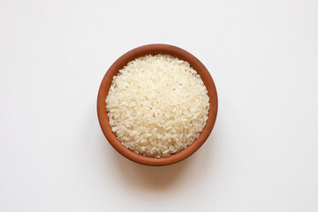 Rice in ceramic bowl. Isolated top view.
