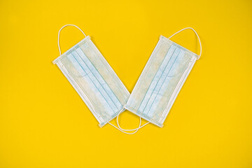 Fototapeta na wymiar Surgical mask with rubber ear straps. Typical 3-ply surgical mask to cover the mouth and nose. Procedure mask from bacteria. Protection concept