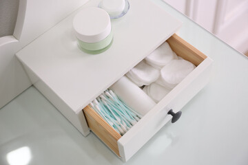 Drawer with cotton buds and pads in dressing table