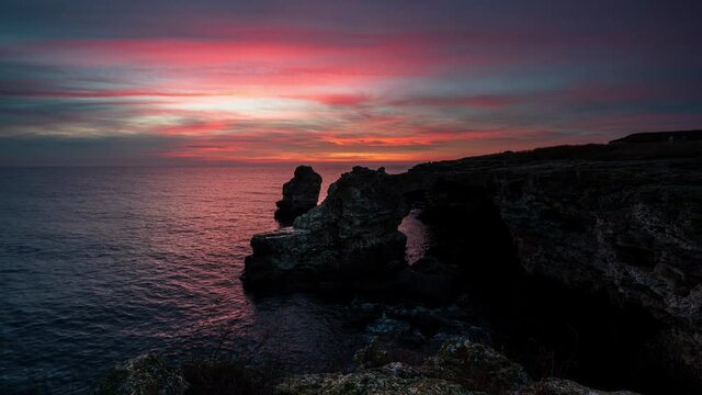 Time lapse with colorful sunrise sky at rocky coastline, the Black Sea coast, Bulgaria