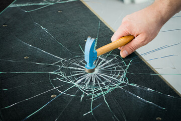 breaking safety glass with a hammer