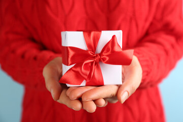 Woman holding gift box, closeup. Valentine's Day celebration