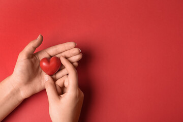 Woman holding decorative heart on red background, top view with space for text. Happy Valentine's Day