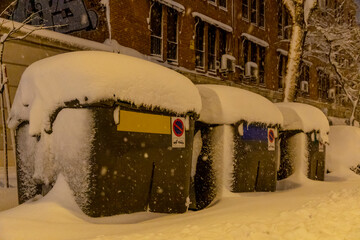 Madrid, Spain; January 9, 2021: Historic snow in the capital. Snow-covered garbage container.
