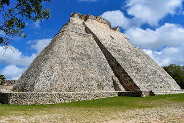 The side view of the great pyramid in Uxmal with a blue sky