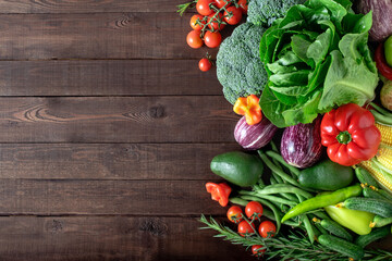 Fototapeta na wymiar Fresh organic vegetables on a wooden background with copy space. Top view