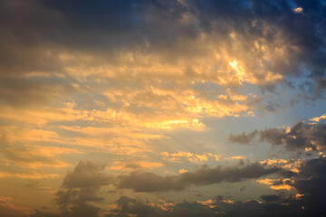 Golden sunset clouds in sky