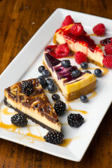 Cheesecake. Traditional Classic New York Style cheesecake dessert topped with fresh starwberry and a a strawberry sauce. A bakery or pastry shop favorite. 
