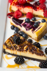Cheesecake. Traditional Classic New York Style cheesecake dessert topped with fresh starwberry and a a strawberry sauce. A bakery or pastry shop favorite. 