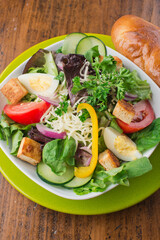 Salad. Garden Salad. Classic American or French restaurant salad made with kale, Arugula, almonds, blueberries, walnuts, tomatoes, bacon, blue cheese, eggs, avocado, tossed with olive oil.