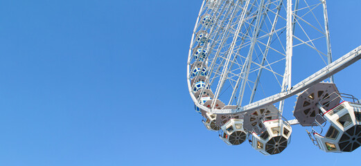 Festival ferris wheel on blue sky background