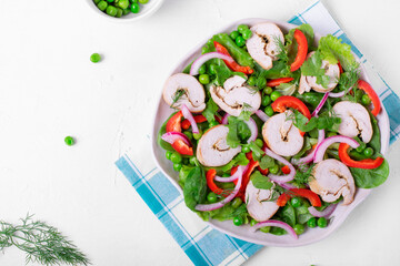 Salad with turkey rolls, green peas, bell pepper, Spanish onion, spinach and lettuce on the big serving dish