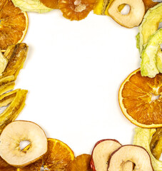 Frame of fruit chips. Healthy and fashionable snack. Trendy eats. Dried slices of orange, apple, pineapple, peach and banana with space for writing. Super food, top view, copy space