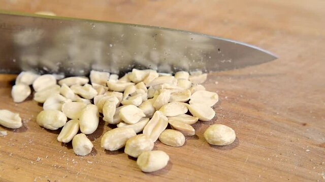 Peanut chopping knife on a wooden board