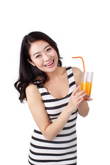 Young woman in a striped dress drinking a glass of orange juice