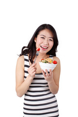 Young woman in a striped dress holding a bowl of fruits