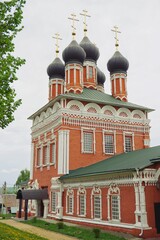 Fototapeta na wymiar red and white Orthodox Church on a cloudy summer day, Bolkhov, Russia