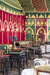 Fototapeta na wymiar Hookahs on some tables, inside an arabian tea house, set up into a tent