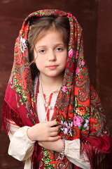 A girl in a Russian outfit with a can of black caviar. Pancake week