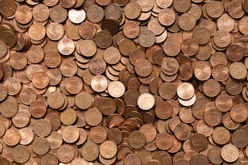 A lot of small euro cent coins from change. Thousands of hard cash pieces in copper color viewed from top down.