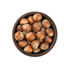 Hazelnuts on a old wooden bowl isolated over white background