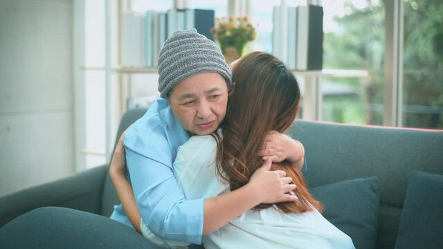 Cancer patient woman hugging her daughter