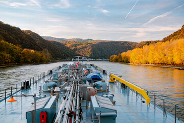 Binnenvaart, Translation Inlandshipping on the river rhein in Germany during sunset hours, Gas...
