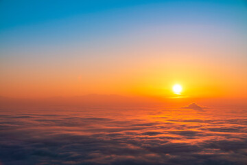 Beautiful sunset sky above clouds, dramatic sunset sky. Nature background, aerial view.