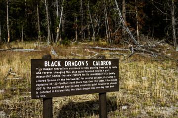 Close up of wooden black dragon's caldron sign in yellowstone national park in america