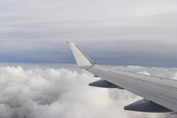 Fototapeta na wymiar Beautiful white clouds floating high angle air, viewed from airplane window.
