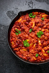 Vegetarian vegan mince chili con carne served in cast iron skillet pan