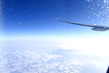 Fototapeta na wymiar Beautiful horizon blue sky with airplane wing fiying on the air. Viewed from airplane window.