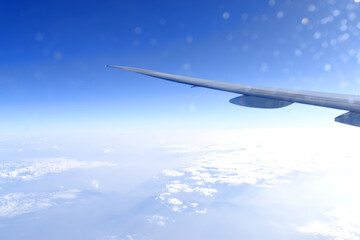 Fototapeta na wymiar Beautiful horizon blue sky with airplane wing fiying on the air. Viewed from airplane window.